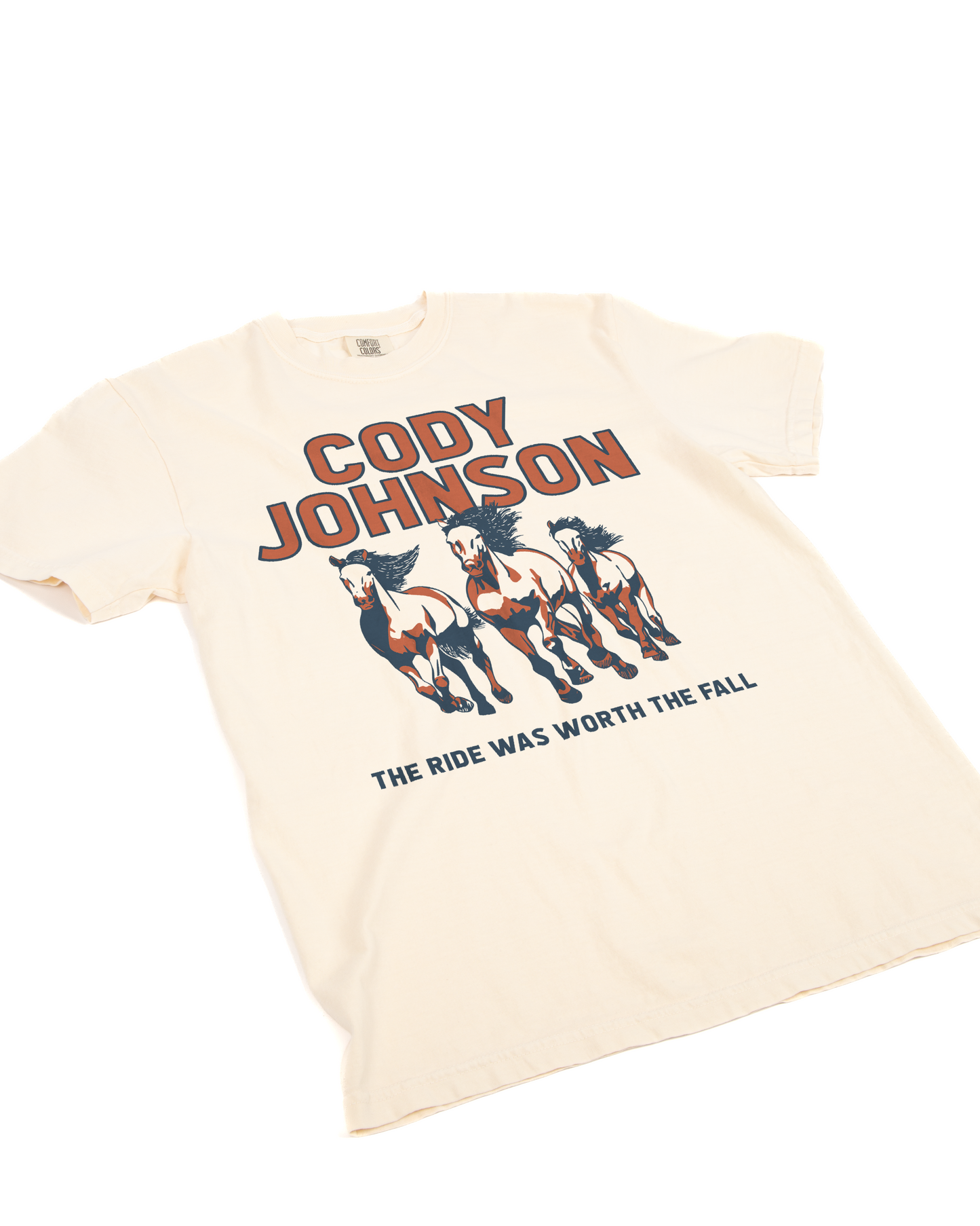 Beige t-shirt with graphic of horses and text 'Cody Johnson The Ride Was Worth The Fall'