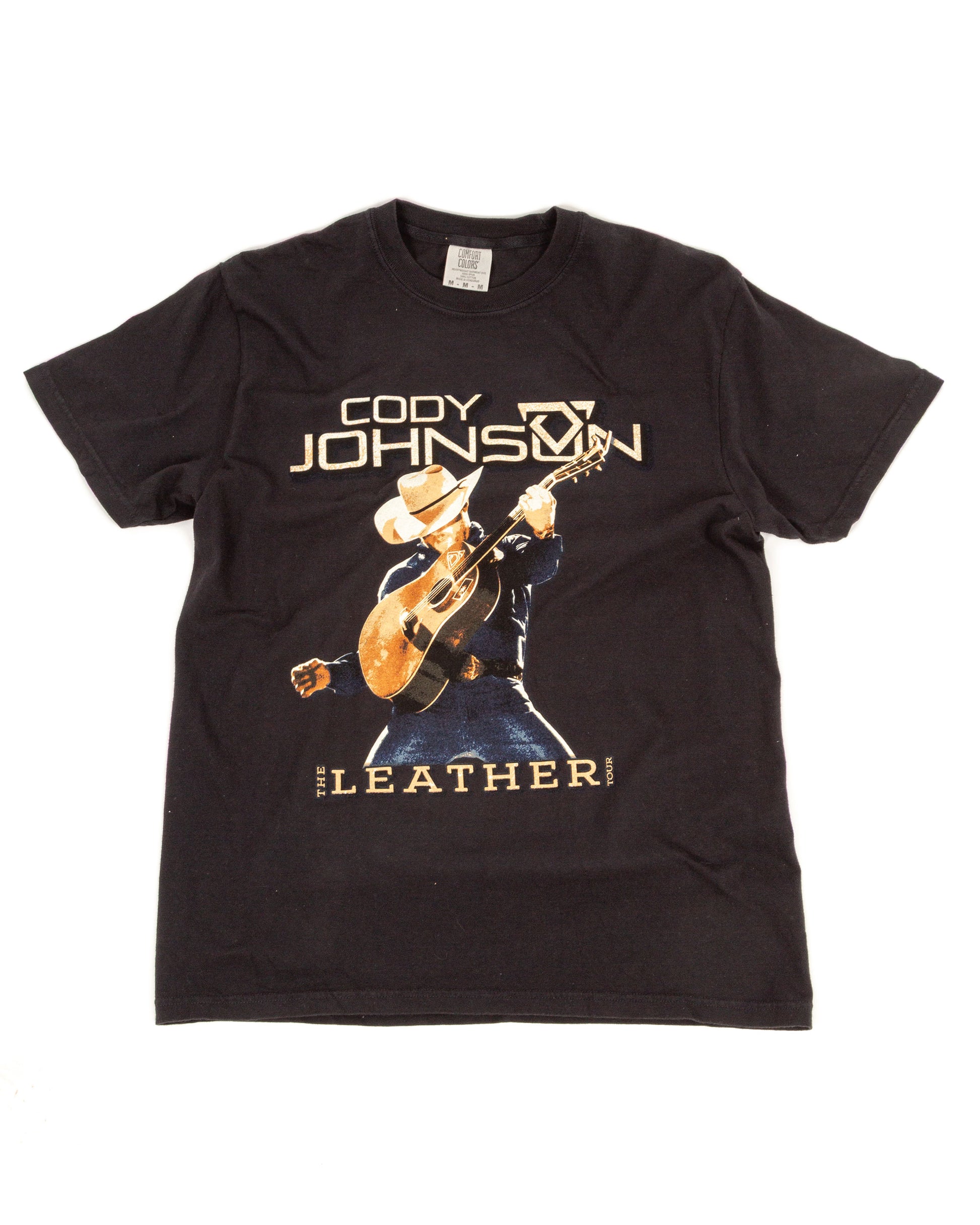 Black t-shirt with a graphic of a person playing guitar and text on a white background