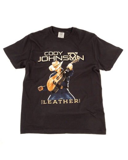 Black t-shirt with a graphic of a person playing guitar and text on a white background