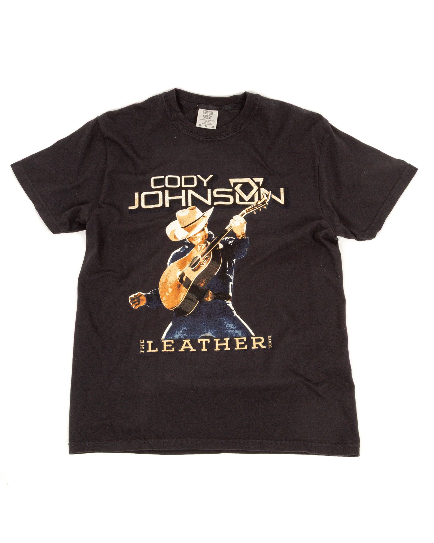 Black t-shirt with a graphic of a person playing guitar and text on a white background