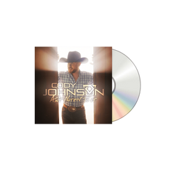 Vinyl record with a cover featuring a person wearing a cowboy hat and plaid shirt, with 'Cody Johnson' and album title on it.