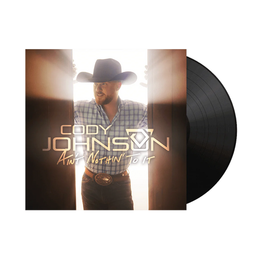 Vinyl record with a cover featuring a man in a cowboy hat and plaid shirt, with 'Cody Johnson' and album title on it.
