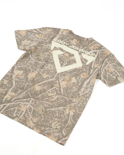A short-sleeve crewneck t-shirt featuring a brown and beige woodland camouflage pattern with a large COJO Bull Logo and 'Cody Johnson' text across the back