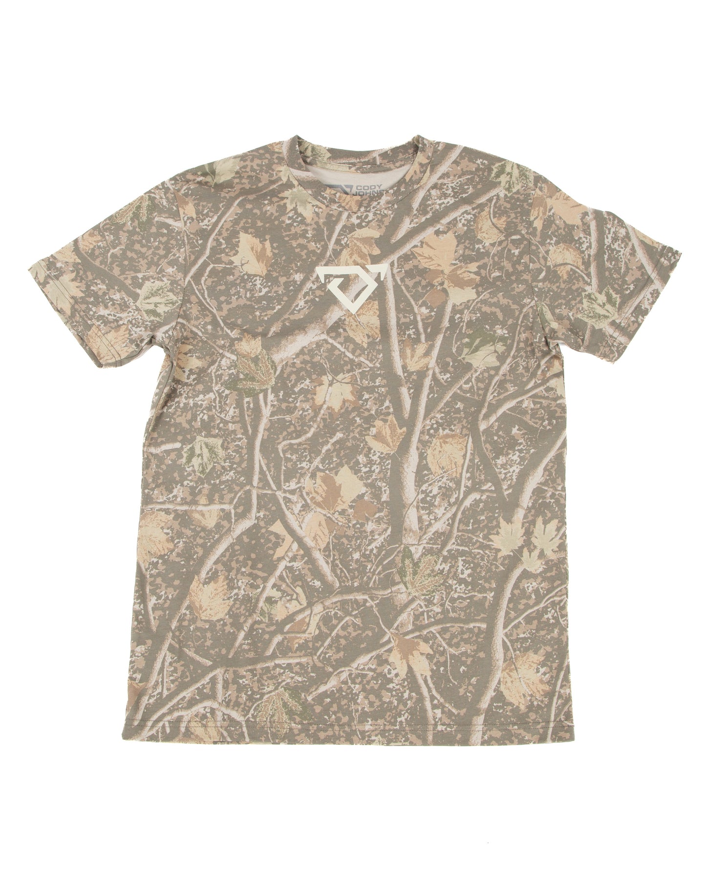 A short-sleeve crewneck t-shirt featuring an all-over camouflage pattern of branches and leaves in shades of brown, beige, and gray, with a small cream COJO bull logo on the center chest.