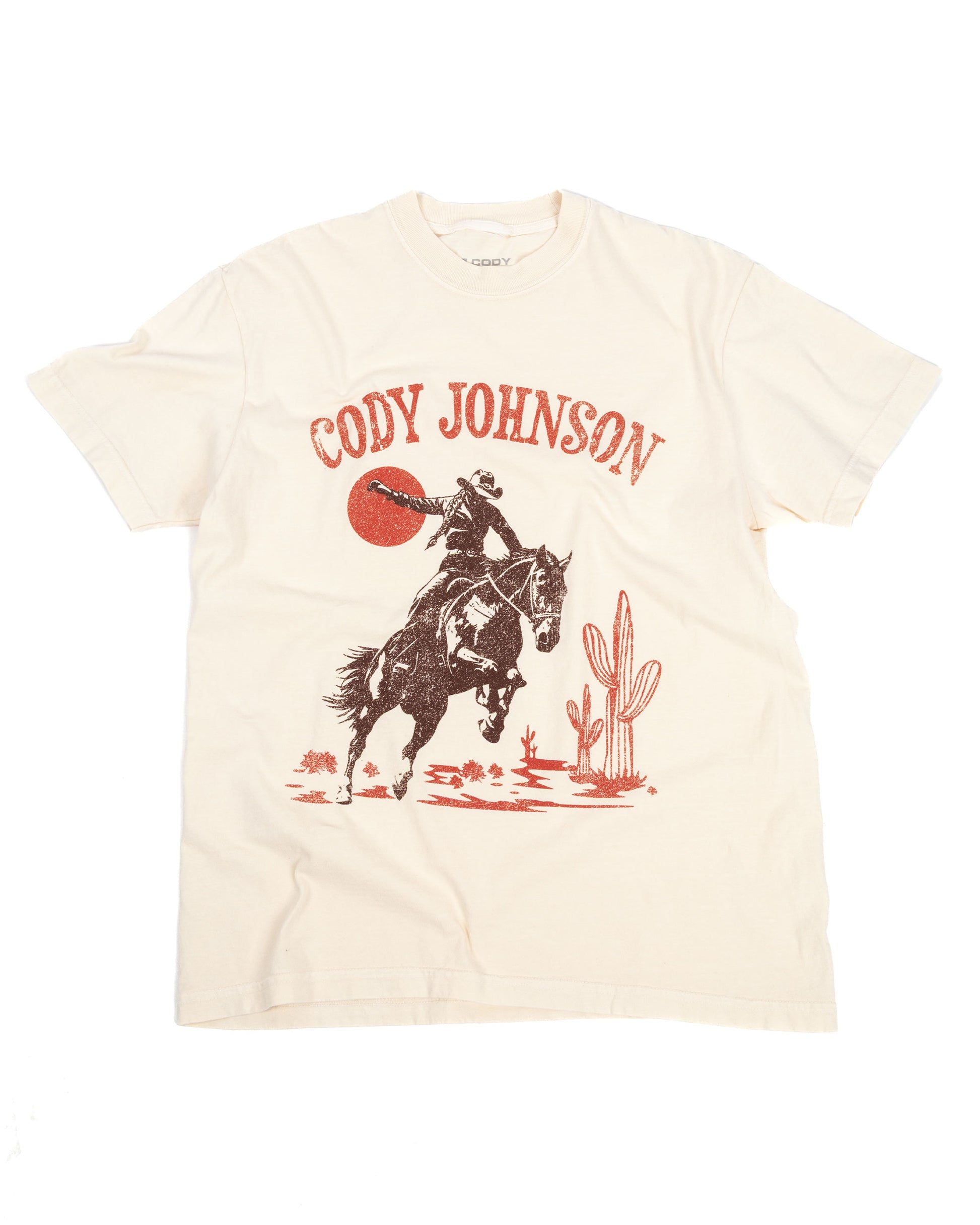 Beige t-shirt with a graphic of a horse and cactus, featuring the text 'Cody Johnson'.