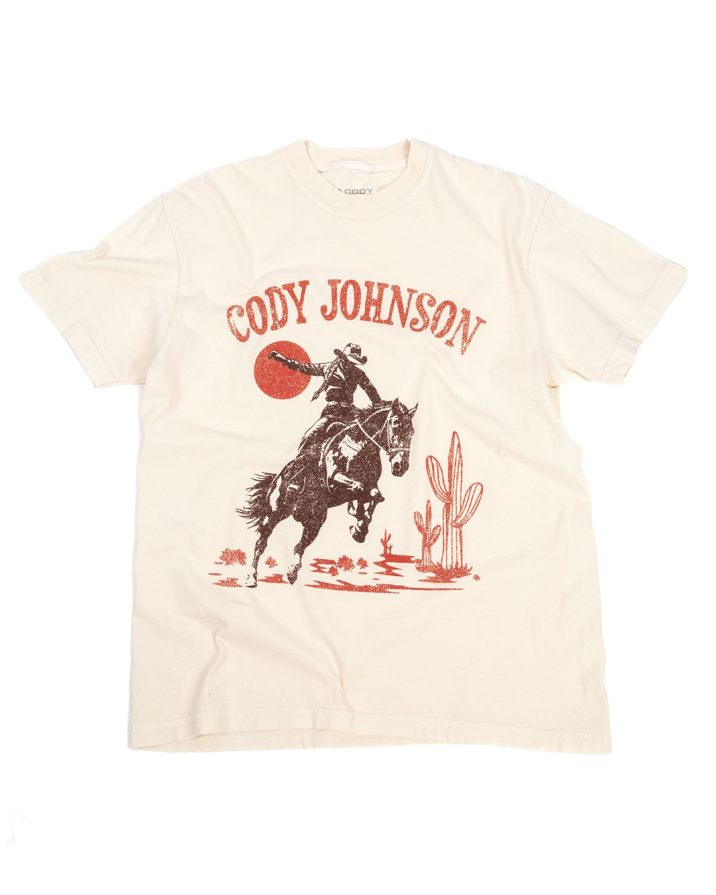 Beige t-shirt with a graphic of a horse and cactus, featuring the text 'Cody Johnson'.