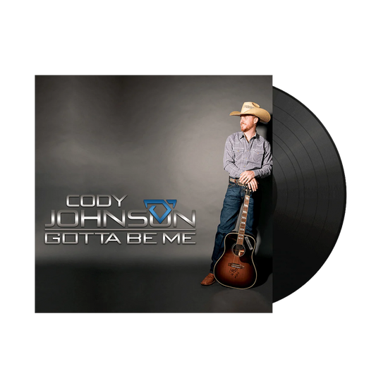 Vinyl record with a cover featuring a person holding a guitar, labeled 'Cody Johnson Gotta Be Me'.